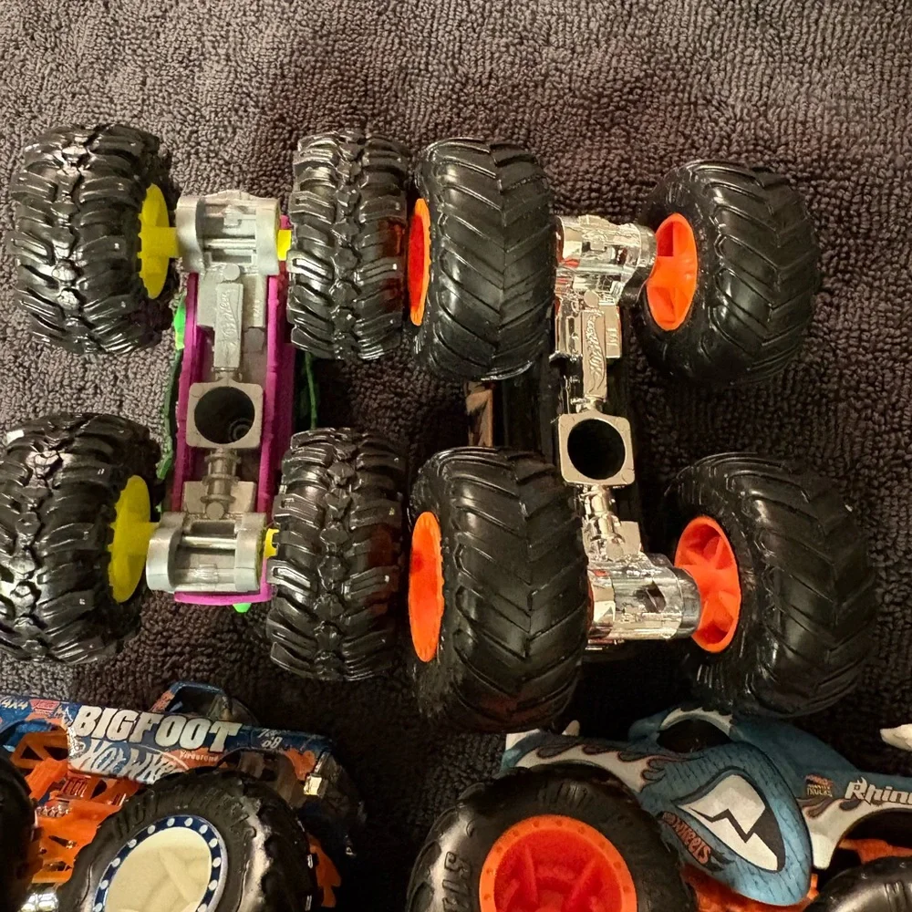 Hot Wheels 4 lot of Monster Truck Toys. Assorted Colors (Green, Orange, Blue)